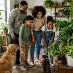 Family admiring beautiful indoor plants at home, showing the benefits of indoor plants for creating a welcoming and relaxing living space.