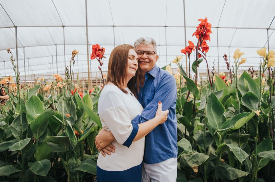 Photo of a lovely couple enjoying the benefits of indoor plants outside their home.